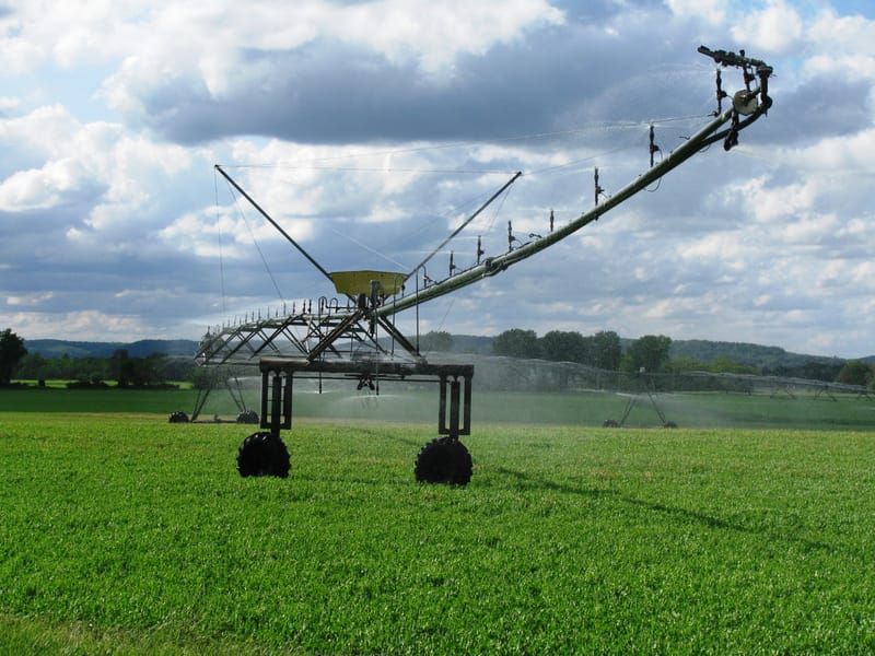 Centre-pivot irrigation system watering a green field
